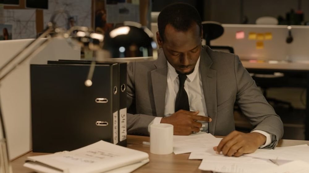 business-insurance-application-documents Business professional reviewing paperwork at an office desk
