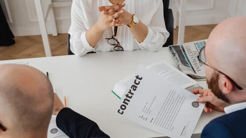 business-liability-insurance-contract-review Business professionals reviewing a contract during a meeting