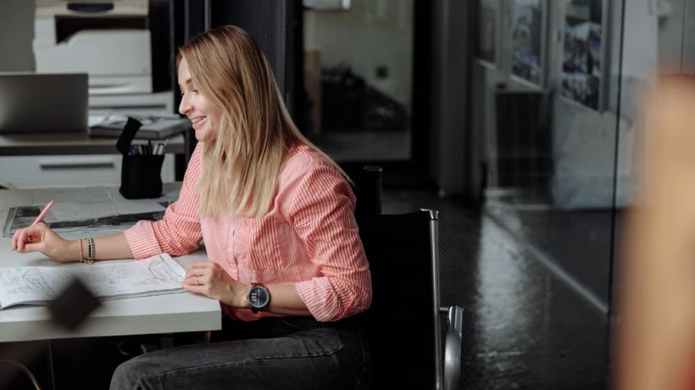 business-owner-reviewing-insurance-costs Business owner reviewing documents at a desk in an office