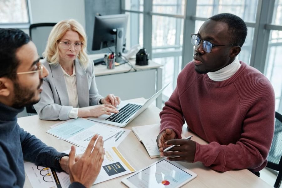 choosing-employee-benefits-package Business professionals reviewing employee benefits information and plan documents during a meeting