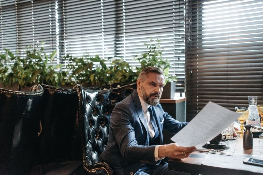 employer-reviewing-insurance-policy business owner reviewing an insurance document at a table