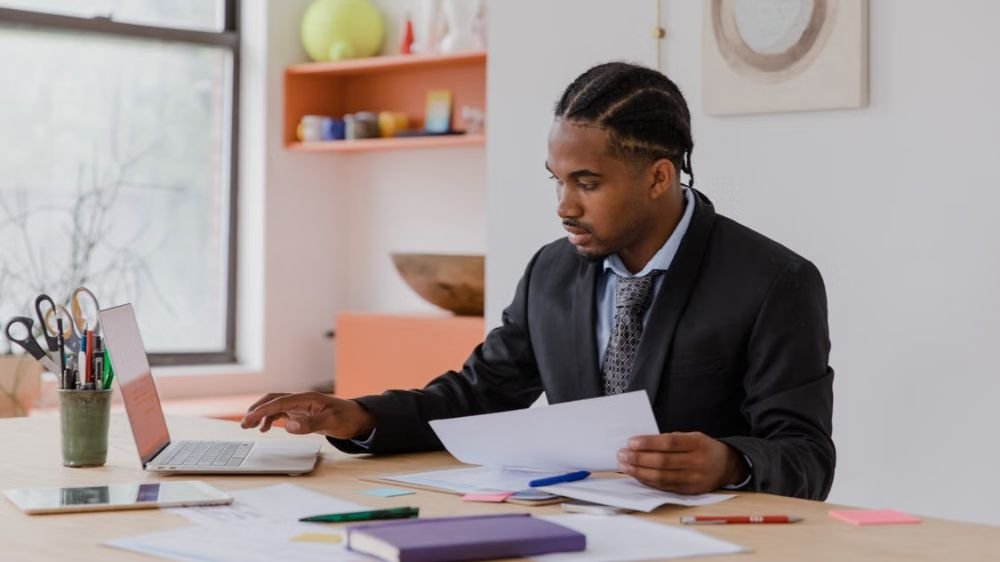 subcontractor-insurance-document-review Business professional reviewing insurance documents at a desk with a laptop